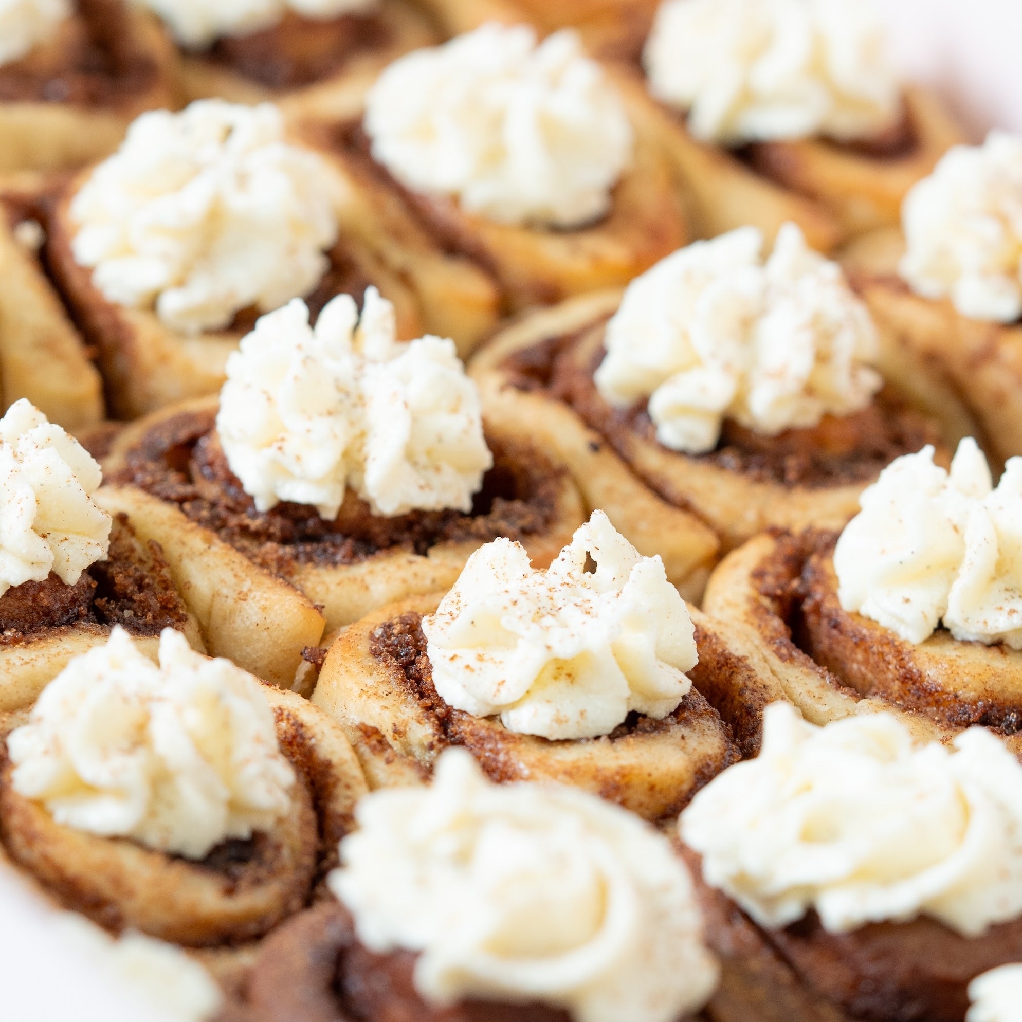 Close-up of mini cinnamon rolls with cream cheese frosting