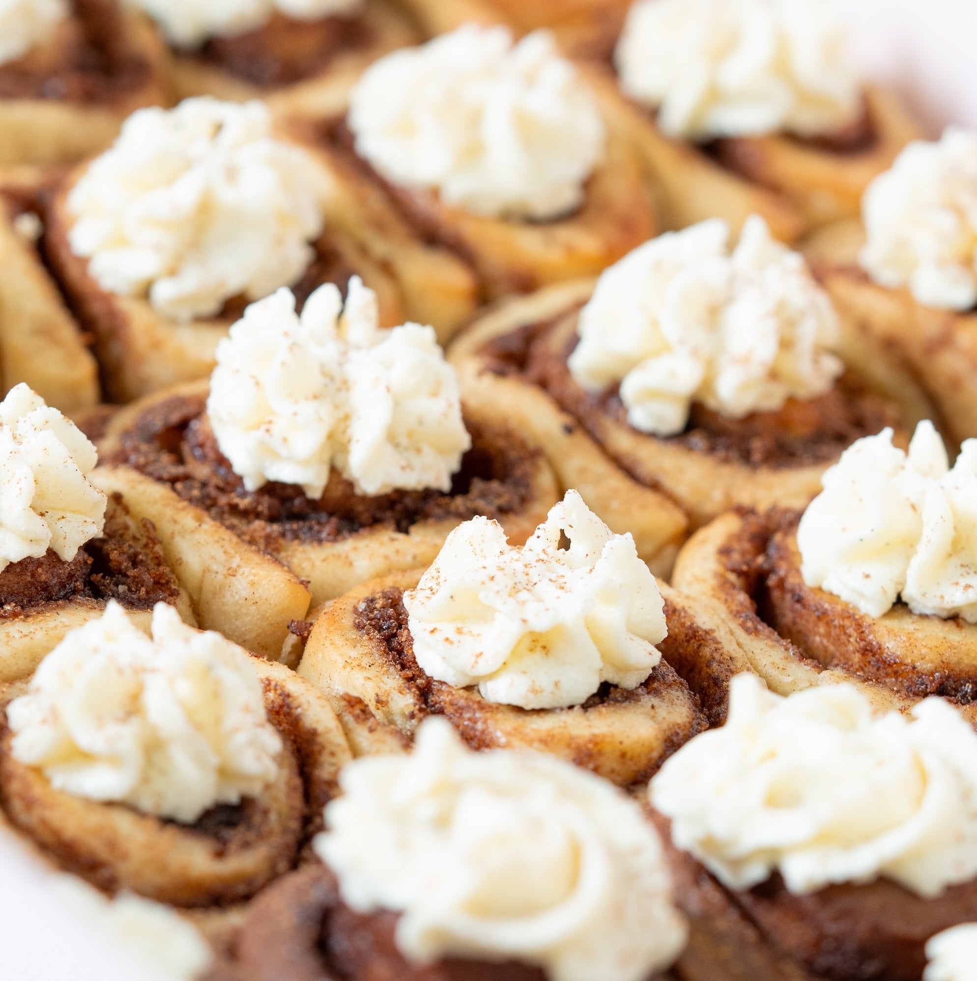 Close-up of mini cinnamon rolls with cream cheese frosting