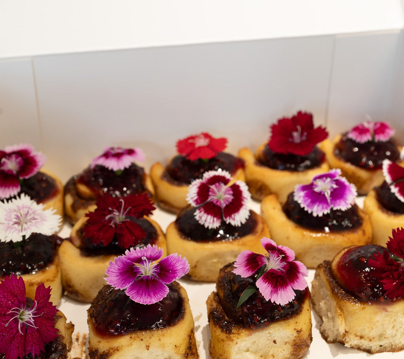 Mini vegan Cinnamon rolls with floral decorations 